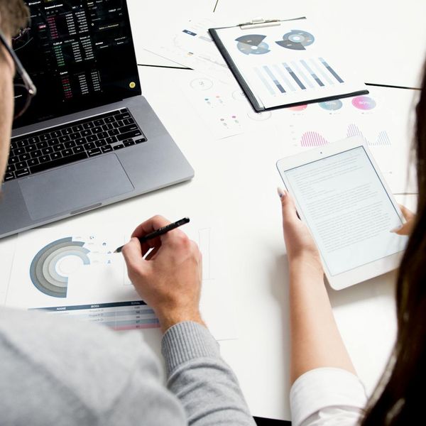 Man in office examining stock market data visualization